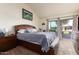 Spacious primary bedroom with patio access and wood furniture at 25239 S Glenburn Dr, Sun Lakes, AZ 85248
