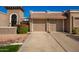 Two-car garage with Spanish-style architecture and landscaping at 25239 S Glenburn Dr, Sun Lakes, AZ 85248