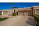 Two-car garage, Spanish style home with mature landscaping at 25239 S Glenburn Dr, Sun Lakes, AZ 85248