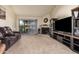 Living room with fireplace, TV, and patio access at 25239 S Glenburn Dr, Sun Lakes, AZ 85248