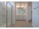 Bright bathroom featuring a glass-enclosed shower and dual sink vanity at 40538 W Crane Dr, Maricopa, AZ 85138