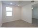 This bedroom is a clean and bright space with neutral tile flooring and a window at 40538 W Crane Dr, Maricopa, AZ 85138