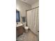 Cozy bathroom with neutral tones, tiled floors, and a shower with a striped curtain at 4213 E Edgemont Ave, Phoenix, AZ 85008