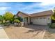 Tan two-story house with brick paver driveway and landscaped yard at 4213 E Edgemont Ave, Phoenix, AZ 85008