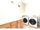 Laundry room with washer, dryer, and cabinets at 4213 E Edgemont Ave, Phoenix, AZ 85008