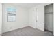 Well-lit bedroom with carpet, a window, and a closet at 4235 E Brook Lynn Pl, San Tan Valley, AZ 85143