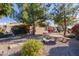 Landscaped backyard with a stone patio and picnic table at 6202 E Mckellips Rd # 117, Mesa, AZ 85215