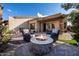 Relaxing backyard patio with fire pit and seating area at 6202 E Mckellips Rd # 117, Mesa, AZ 85215