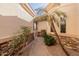 Charming courtyard with a stone path and beautiful plants at 6202 E Mckellips Rd # 117, Mesa, AZ 85215