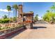 Gated community entrance with stonework and landscaping at 6202 E Mckellips Rd # 117, Mesa, AZ 85215