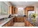 Kitchen with wood cabinets, granite countertops, and a large island at 6202 E Mckellips Rd # 117, Mesa, AZ 85215