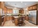 Modern kitchen with wood cabinets, granite counters, and stainless steel appliances at 6202 E Mckellips Rd # 117, Mesa, AZ 85215