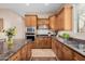 Modern kitchen with wood cabinets, granite countertops and island at 6202 E Mckellips Rd # 117, Mesa, AZ 85215