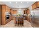 Modern kitchen with wood cabinets, granite counters, and stainless steel appliances at 6202 E Mckellips Rd # 117, Mesa, AZ 85215