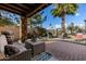 Covered patio with seating and grill, overlooking a golf course at 6202 E Mckellips Rd # 117, Mesa, AZ 85215