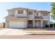 Two-story house with a three-car garage and landscaped front yard at 6422 S 26Th Ln, Phoenix, AZ 85041