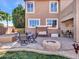 Relaxing backyard patio with fire pit, seating area, and built-in BBQ at 6868 W Cottontail Ln, Peoria, AZ 85383