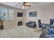 Cozy bedroom featuring a sitting area, desk, and a ceiling fan at 6868 W Cottontail Ln, Peoria, AZ 85383