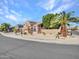 Two-story house with tan exterior, three-car garage, and desert landscaping at 6868 W Cottontail Ln, Peoria, AZ 85383