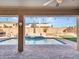 Inviting pool area with spacious patio, covered seating, and lush landscaping at 6868 W Cottontail Ln, Peoria, AZ 85383