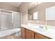 Neutral bathroom featuring a tub with sliding doors, a large mirror, and a single sink vanity at 743 E Horizon Heights Dr, San Tan Valley, AZ 85143