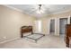 Bedroom showcasing neutral tones, ceiling fan, carpet floors, and adjoining bathroom with walk-in closet at 743 E Horizon Heights Dr, San Tan Valley, AZ 85143