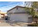 Home featuring a two-car garage, desert-style landscaping, and a peaceful residential setting at 743 E Horizon Heights Dr, San Tan Valley, AZ 85143