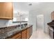 Bright kitchen boasts stainless steel appliances, granite countertops, and open access to dining space at 743 E Horizon Heights Dr, San Tan Valley, AZ 85143