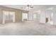 Spacious carpeted living room featuring neutral walls, a ceiling fan, and bright natural light at 743 E Horizon Heights Dr, San Tan Valley, AZ 85143