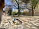 Landscaped backyard with flagstone patio, water feature, and mature trees at 8227 E Sierra Pinta Dr, Scottsdale, AZ 85255