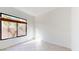 Simple bedroom with large window and tile floors at 8227 E Sierra Pinta Dr, Scottsdale, AZ 85255