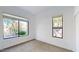 Bright bedroom with two windows and neutral carpet at 8227 E Sierra Pinta Dr, Scottsdale, AZ 85255