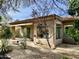 Home's exterior showcasing a patio, mature trees, and stone pathway at 8227 E Sierra Pinta Dr, Scottsdale, AZ 85255