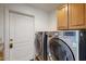 Laundry room with modern washer and dryer, and cabinets at 8227 E Sierra Pinta Dr, Scottsdale, AZ 85255