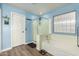 Bathroom features a soaking tub, shower, and blue walls at 8642 W Harmony Ln, Peoria, AZ 85382