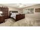 Spacious bedroom with dark wood furniture and ceiling fan at 8642 W Harmony Ln, Peoria, AZ 85382