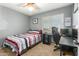 Bright bedroom with a double bed, desk, and window coverings at 8642 W Harmony Ln, Peoria, AZ 85382