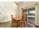 Dining area with wooden table and chairs, and sliding glass doors to backyard at 8642 W Harmony Ln, Peoria, AZ 85382