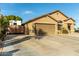 Tan house with RV gate, two-car garage, and spacious driveway at 8642 W Harmony Ln, Peoria, AZ 85382