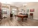 Bright game room featuring a pool table and hardwood floors at 8642 W Harmony Ln, Peoria, AZ 85382