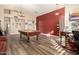 Game room with pool table, hardwood floors, and accent wall at 8642 W Harmony Ln, Peoria, AZ 85382
