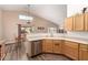 Kitchen features stainless steel dishwasher and light wood cabinets at 8642 W Harmony Ln, Peoria, AZ 85382