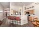 Bright kitchen with light wood cabinets, stainless steel appliances, and breakfast bar at 8642 W Harmony Ln, Peoria, AZ 85382