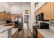 Kitchen boasts stainless steel appliances and light wood cabinets at 8642 W Harmony Ln, Peoria, AZ 85382