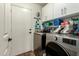 Laundry room with washer, dryer, and storage cabinets at 8642 W Harmony Ln, Peoria, AZ 85382