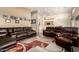Open living room with brown leather sectional sofa and area rug at 8642 W Harmony Ln, Peoria, AZ 85382