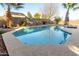 Inviting kidney-shaped pool with surrounding patio at 8642 W Harmony Ln, Peoria, AZ 85382