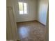 Bright bedroom with tile floors and a window at 887 E Detroit St, Chandler, AZ 85225