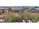 An aerial view of a home with a red tile roof surrounded by lush green trees and landscaping at 9305 E Canyon View Rd, Scottsdale, AZ 85255