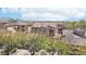 View of a home with a red tile roof with desert landscaping and Mountain View beyond at 9305 E Canyon View Rd, Scottsdale, AZ 85255